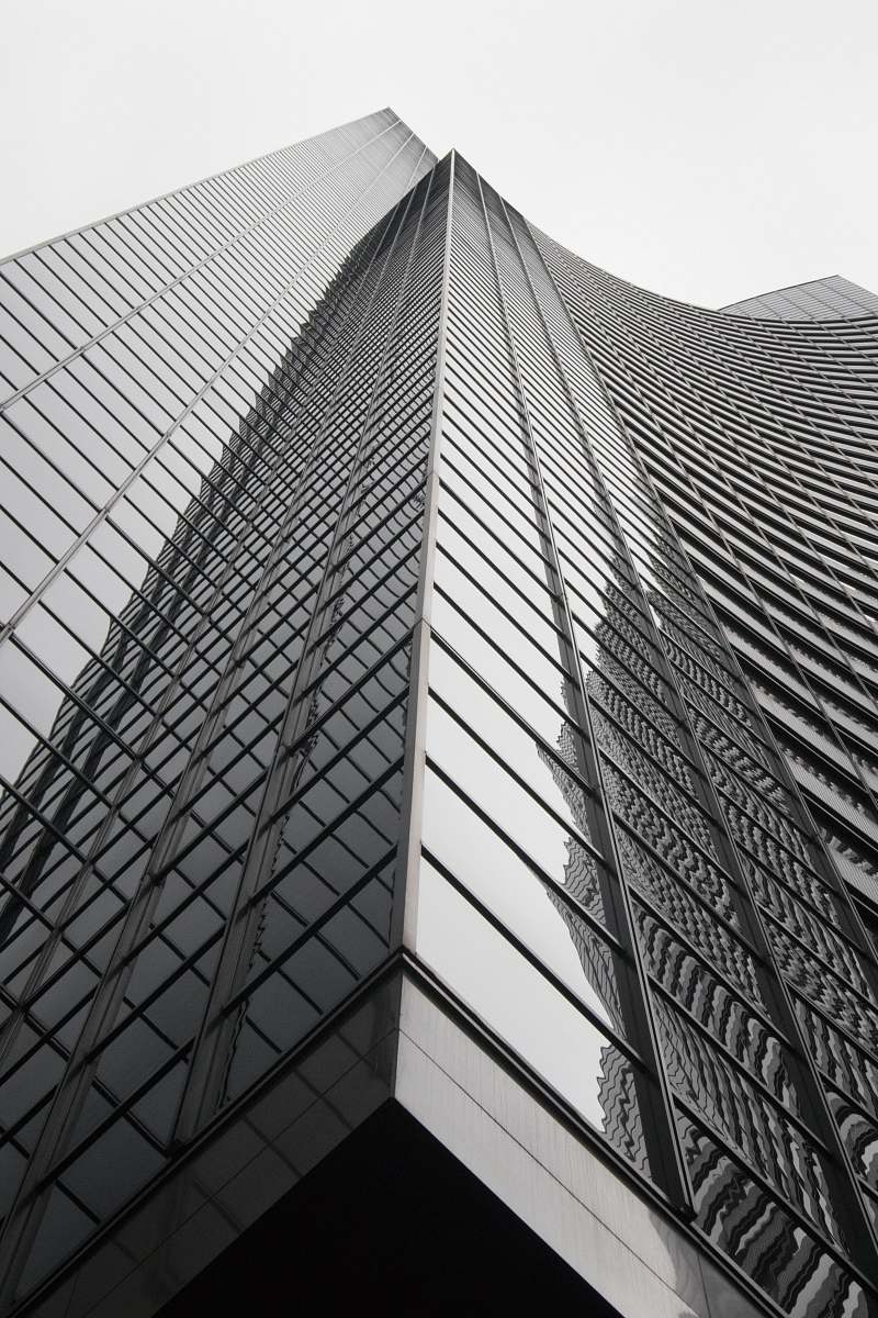 high rise grey curtain building during daytime black-and-white